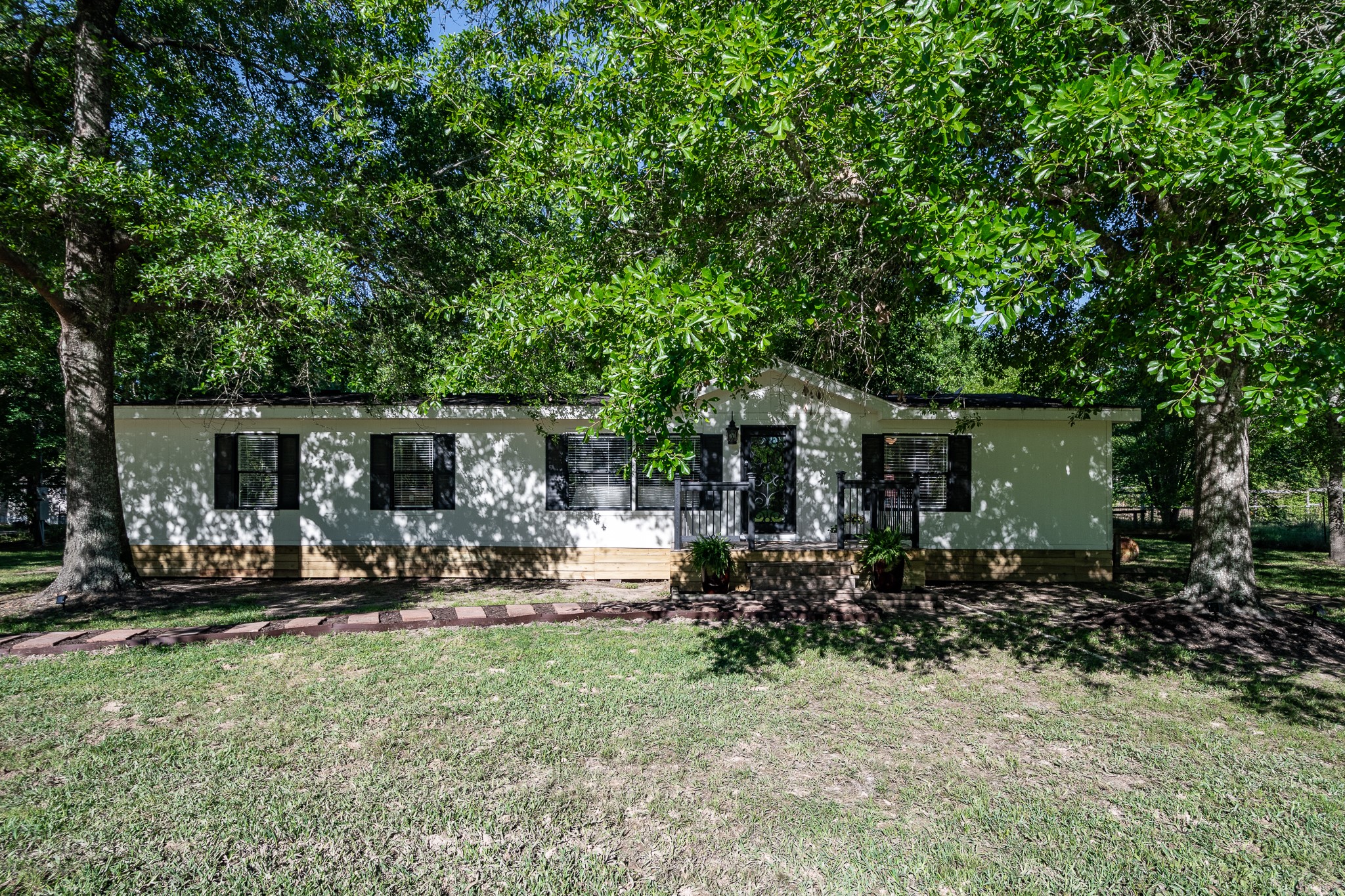 24274 Enloe Road Porter, TX 77365 - Photo 5 of 29 a front view of a house with swing hanging chair