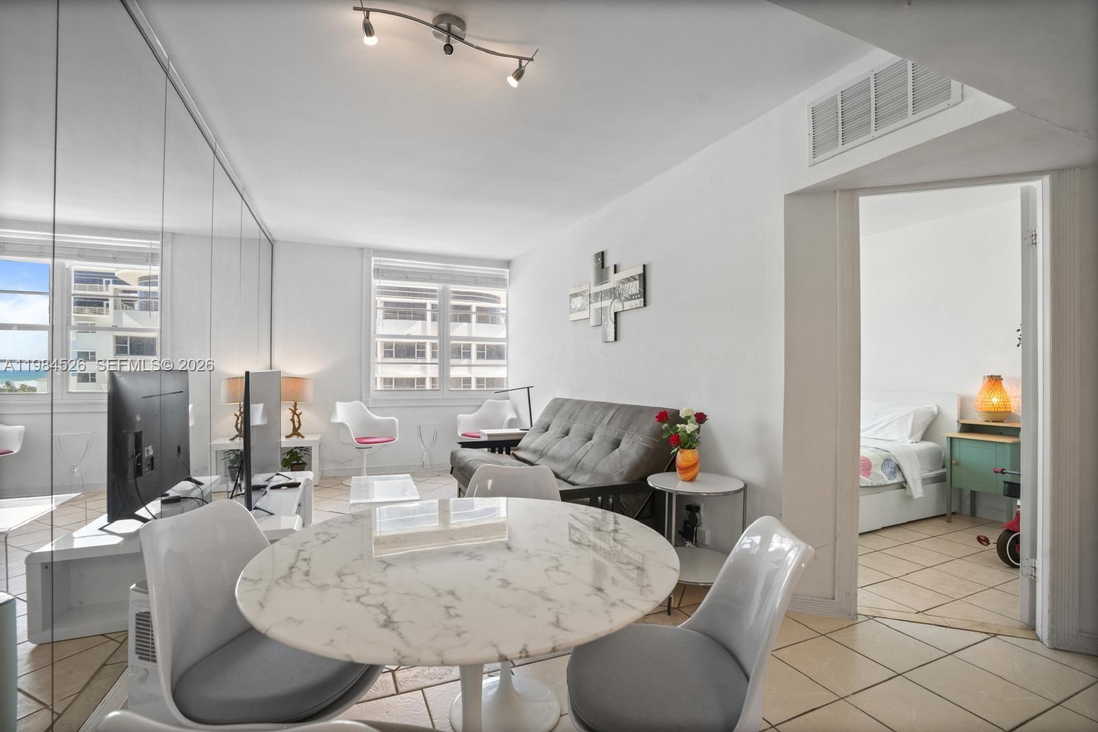 100 Lincoln Road, Unit 825 Miami Beach, FL 33139 - Photo 11 of 51 a living room with furniture and a chandelier