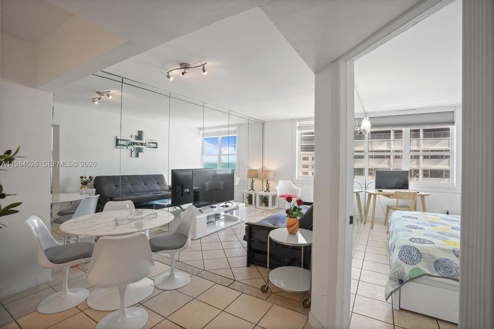 100 Lincoln Road, Unit 825 Miami Beach, FL 33139 - Photo 12 of 51 a living room with furniture and a large window