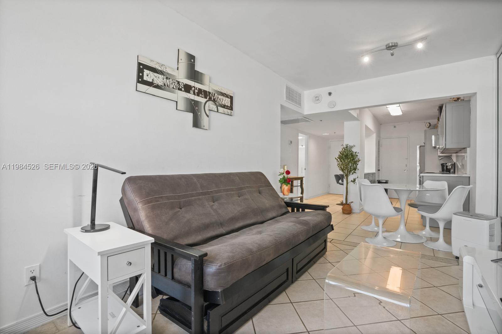 100 Lincoln Road, Unit 825 Miami Beach, FL 33139 - Photo 13 of 51 a living room with couches and kitchen view