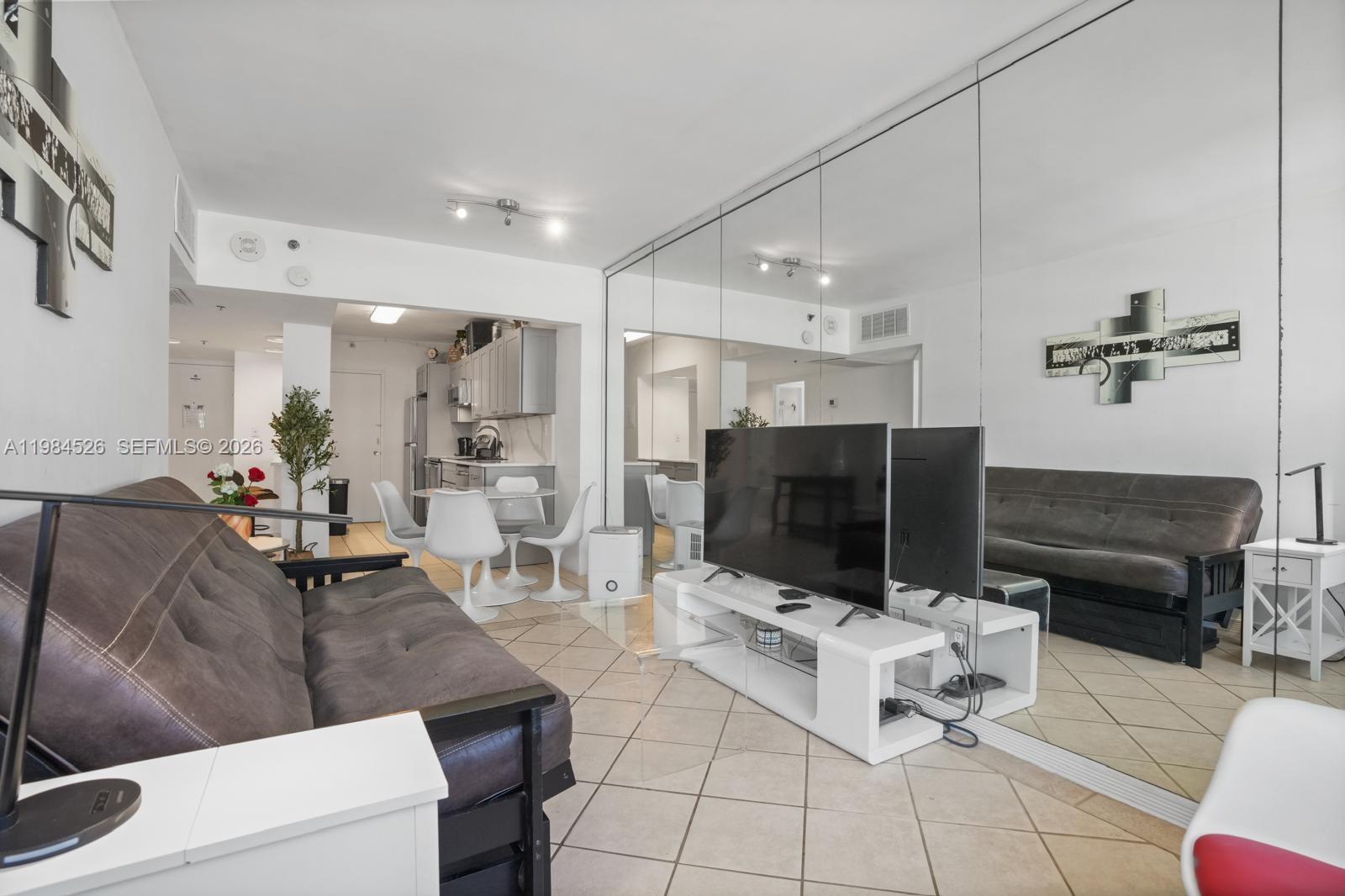 100 Lincoln Road, Unit 825 Miami Beach, FL 33139 - Photo 14 of 51 a living room with furniture and a flat screen tv