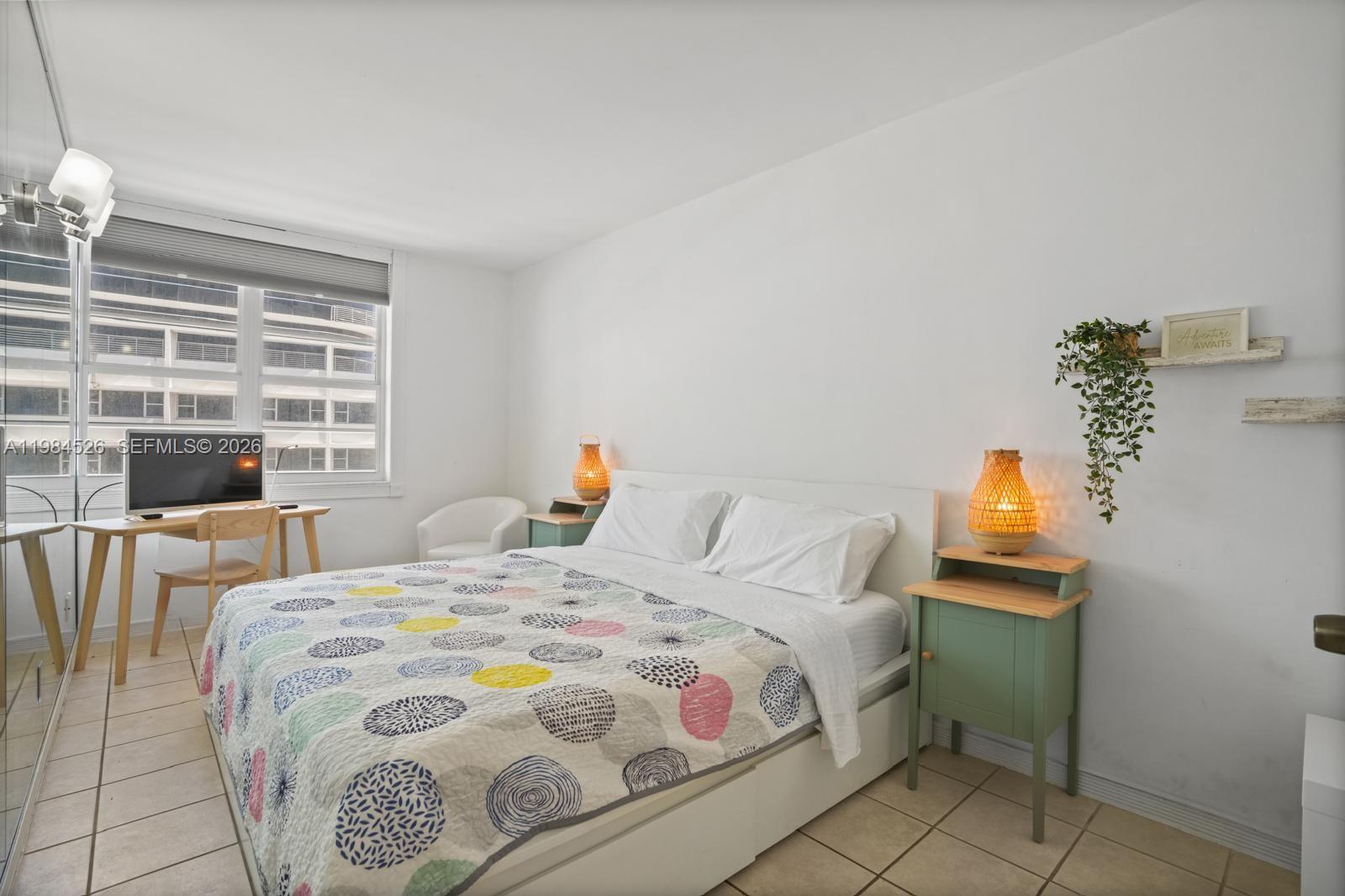 100 Lincoln Road, Unit 825 Miami Beach, FL 33139 - Photo 18 of 51 a bedroom with a bed and a window