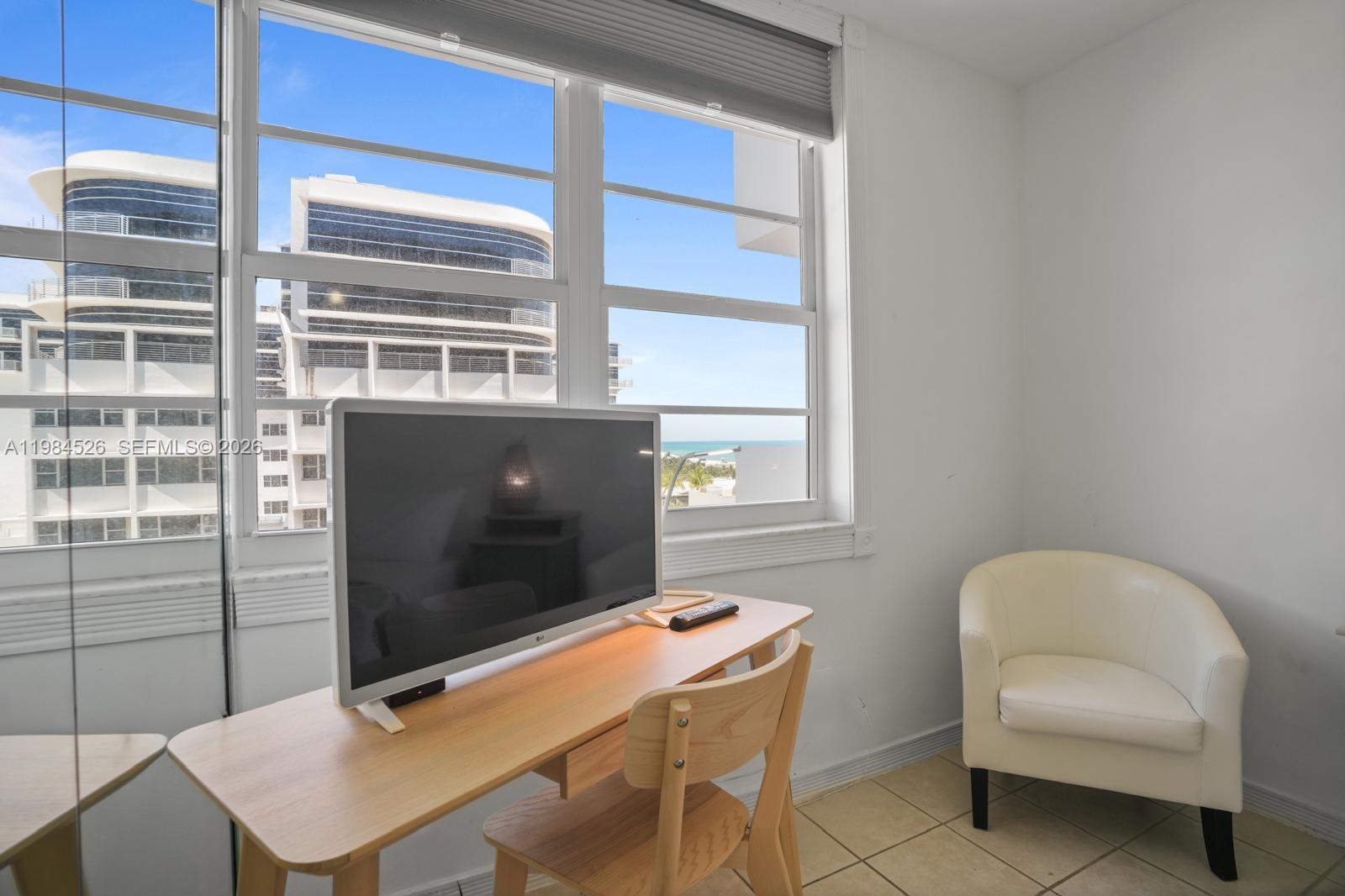 100 Lincoln Road, Unit 825 Miami Beach, FL 33139 - Photo 19 of 51 a living room with a flat screen tv and a window