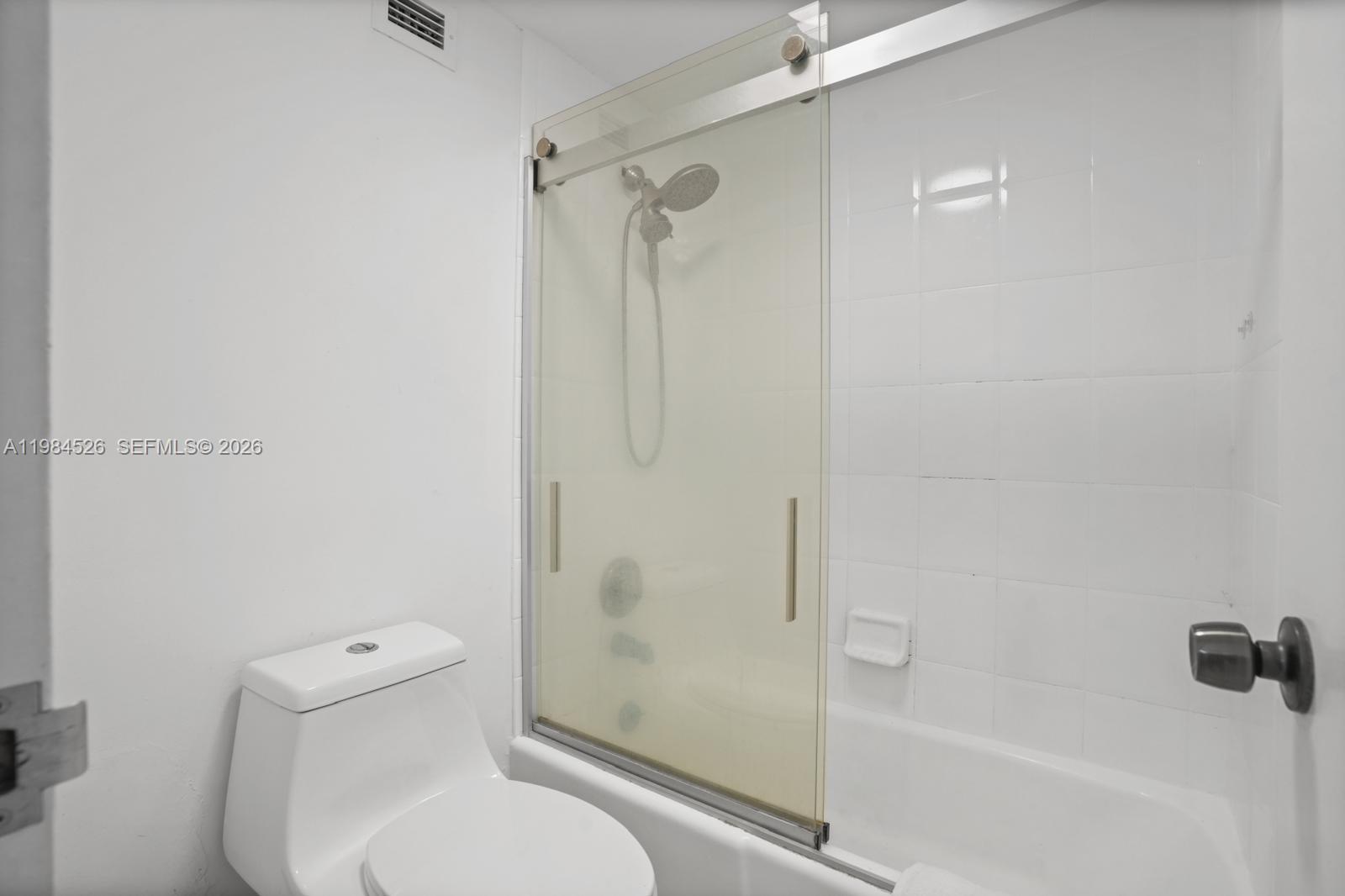 100 Lincoln Road, Unit 825 Miami Beach, FL 33139 - Photo 23 of 51 a white toilet sitting next to a bath tub