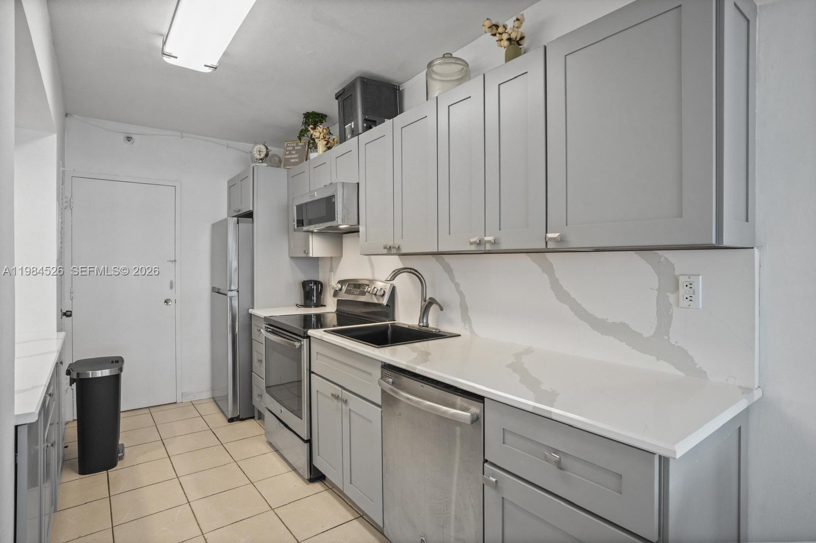100 Lincoln Road, Unit 825 Miami Beach, FL 33139 - Photo 3 of 51 a kitchen with stainless steel appliances granite countertop a sink and a refrigerator