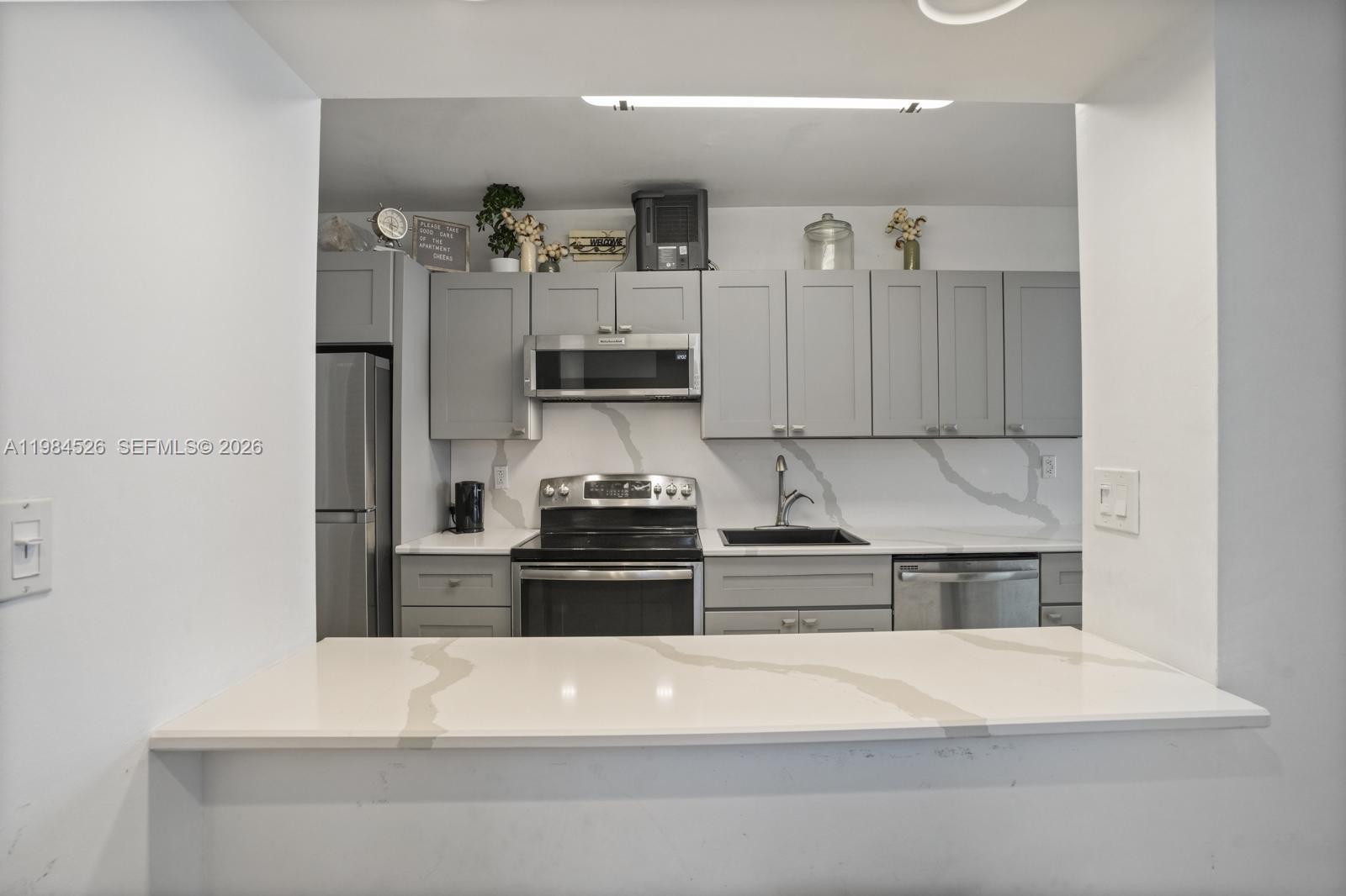 100 Lincoln Road, Unit 825 Miami Beach, FL 33139 - Photo 5 of 51 a kitchen with a refrigerator and a stove top oven