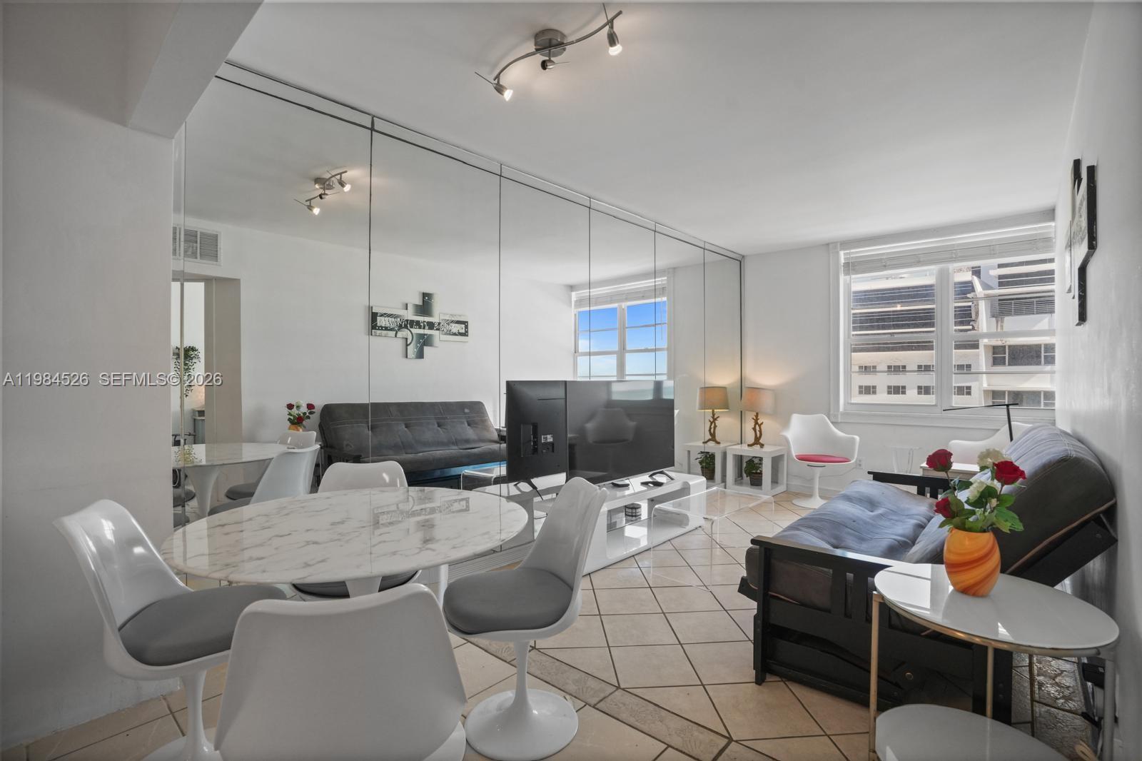 100 Lincoln Road, Unit 825 Miami Beach, FL 33139 - Photo 9 of 51 a living room with furniture and a large window