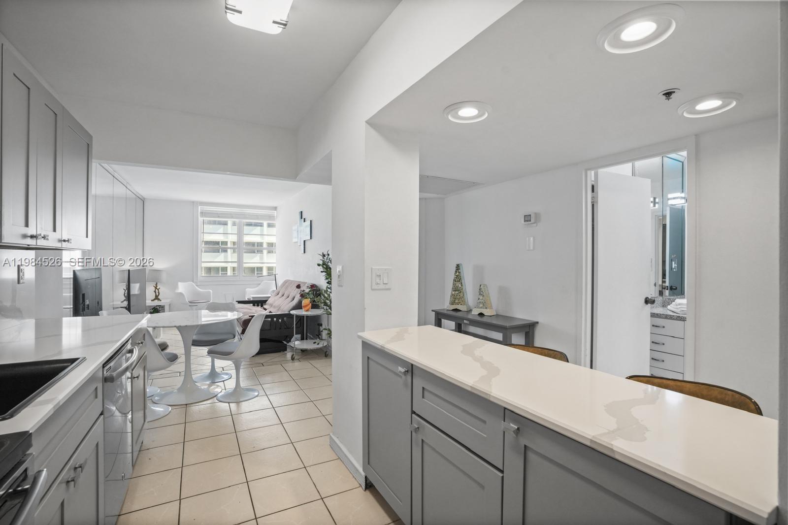 100 Lincoln Road, Unit 825 Miami Beach, FL 33139 - Photo 10 of 51 a kitchen with a sink and white cabinets