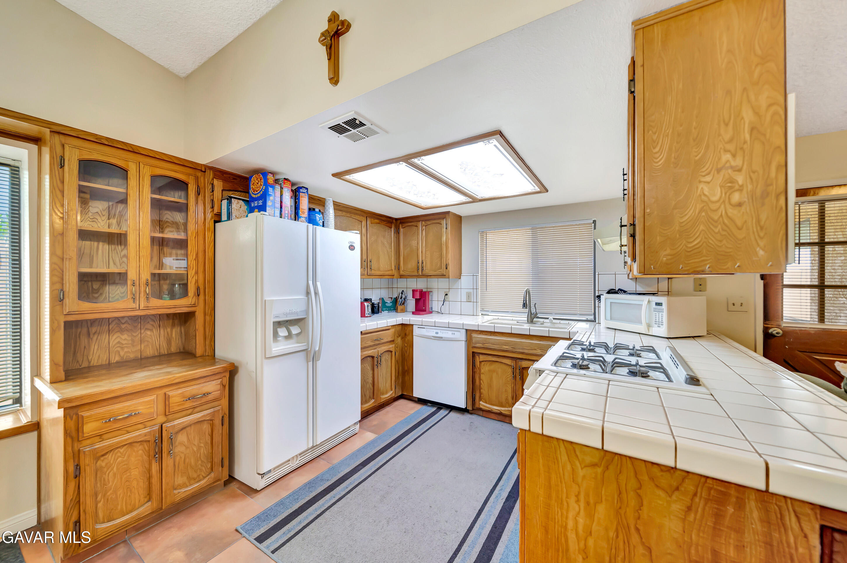 729 North Sunland Drive Ridgecrest, CA 93555 - Photo 16 of 52 a kitchen with a refrigerator and a stove top oven