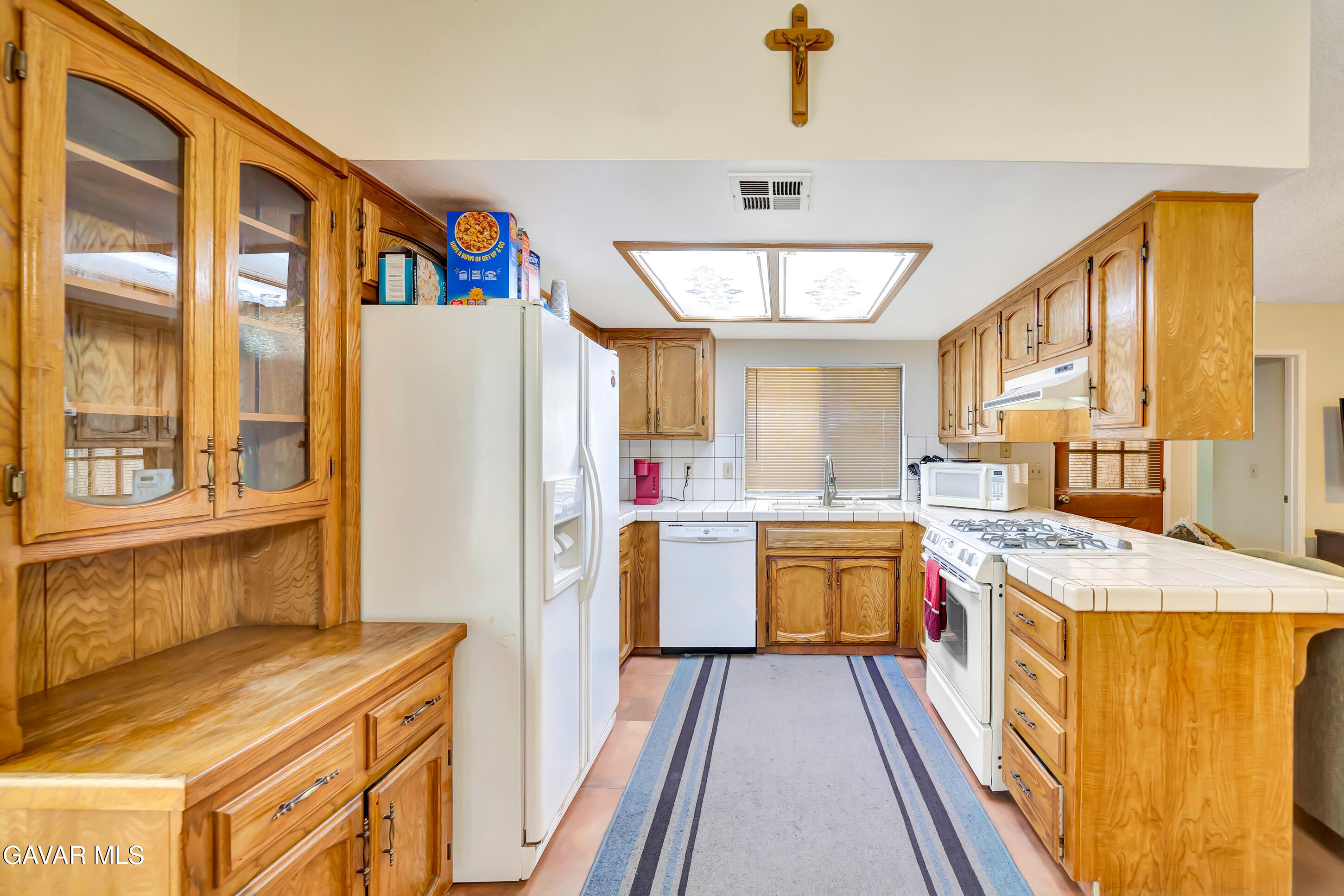 729 North Sunland Drive Ridgecrest, CA 93555 - Photo 17 of 52 a kitchen with a refrigerator a stove top oven a sink and dishwasher