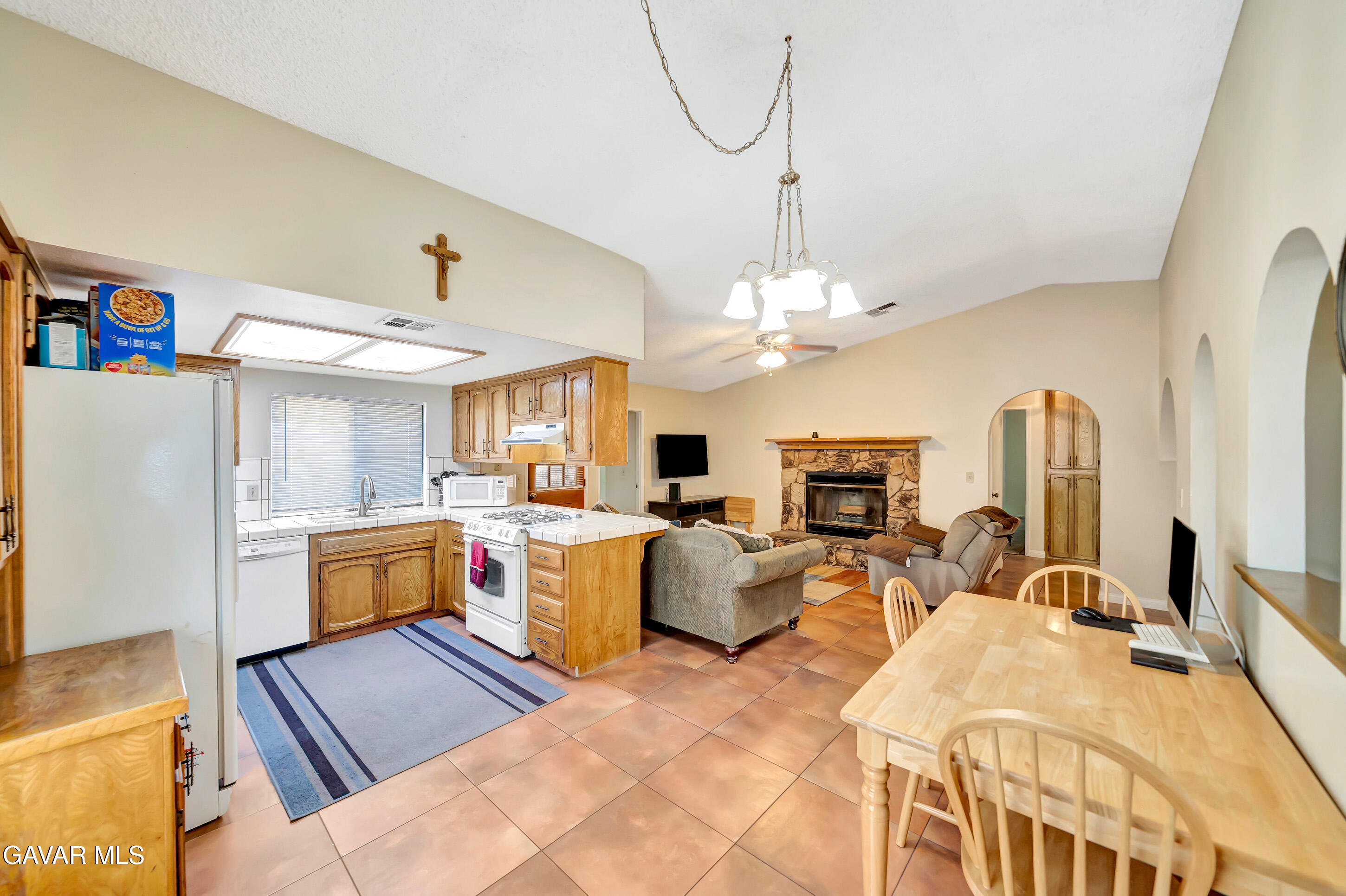 729 North Sunland Drive Ridgecrest, CA 93555 - Photo 18 of 52 a open kitchen with stainless steel appliances granite countertop a sink dishwasher stove refrigerator and couches with wooden floor