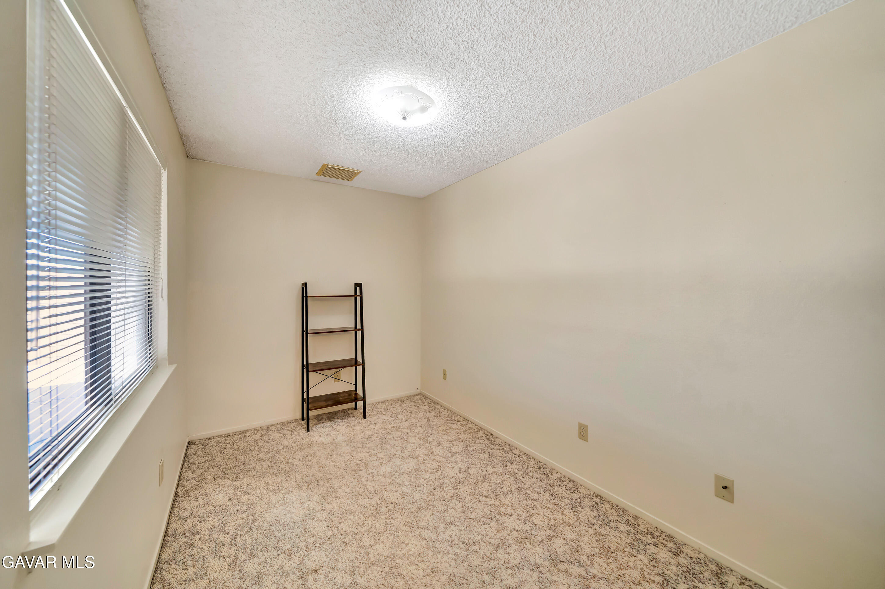 729 North Sunland Drive Ridgecrest, CA 93555 - Photo 21 of 52 an empty room with windows