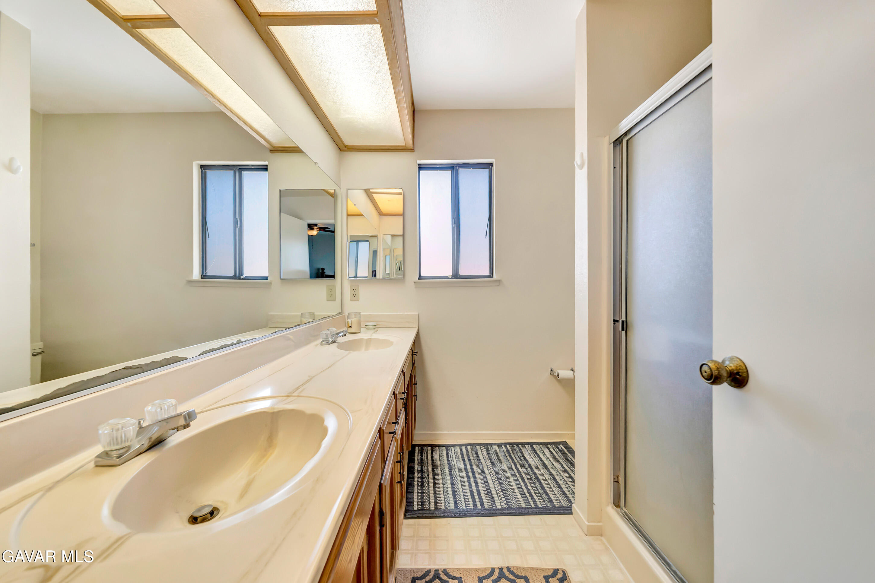 729 North Sunland Drive Ridgecrest, CA 93555 - Photo 27 of 52 a bathroom with a sink and mirror with toilet