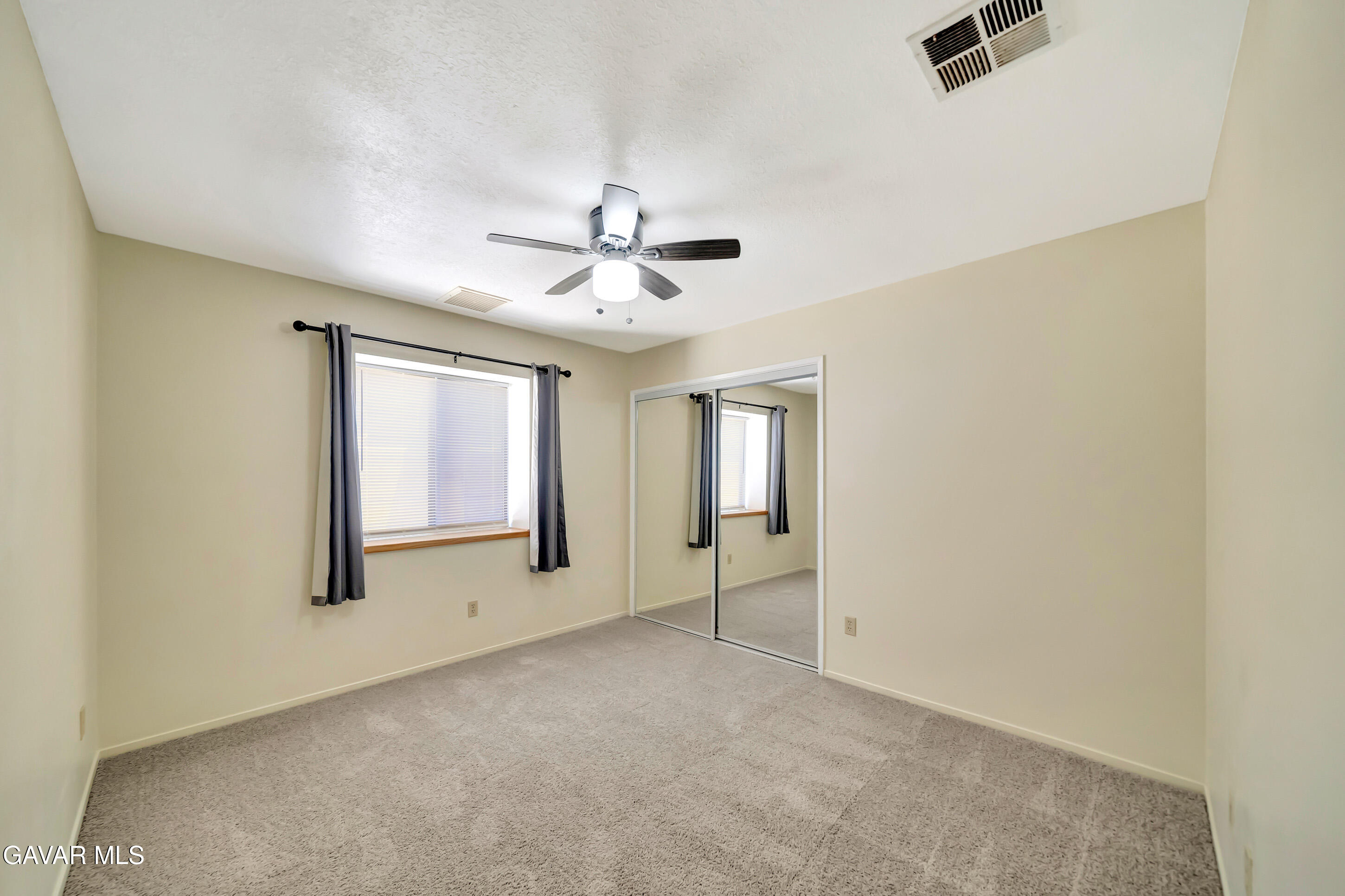 729 North Sunland Drive Ridgecrest, CA 93555 - Photo 33 of 52 an empty room with windows and fan