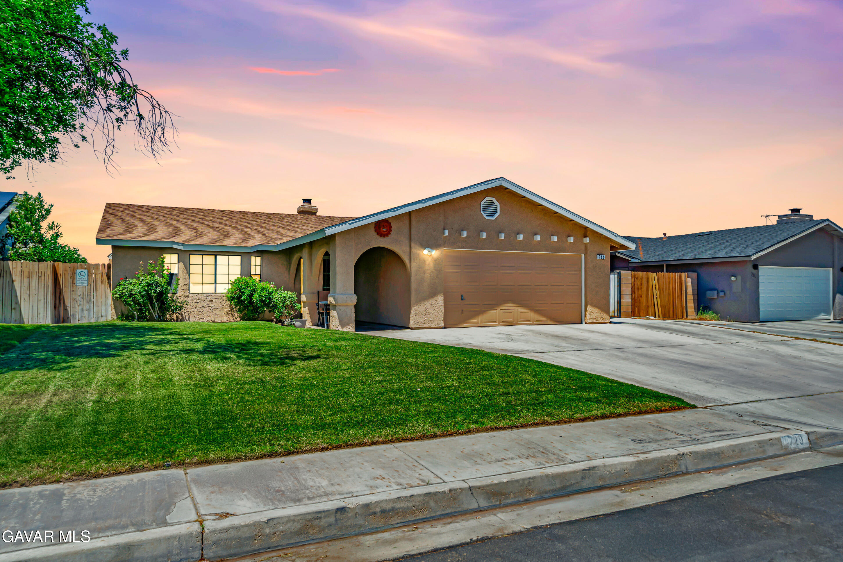 729 North Sunland Drive Ridgecrest, CA 93555 - Photo 52 of 52 a front view of a house with a yard and garage