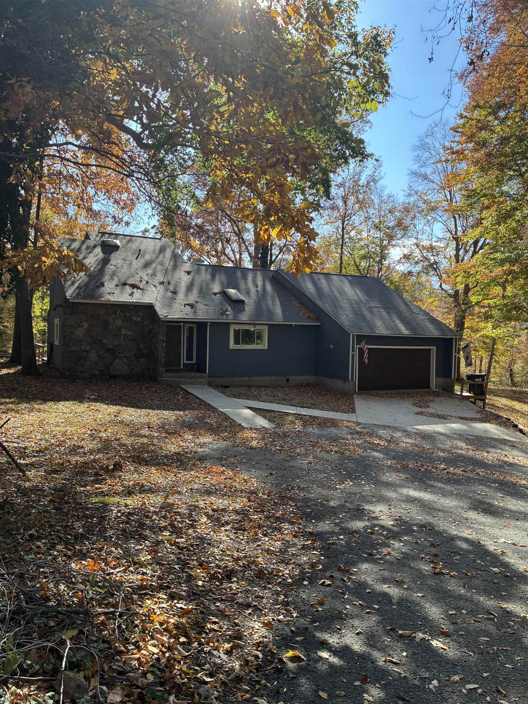a front view of house with yard and trees