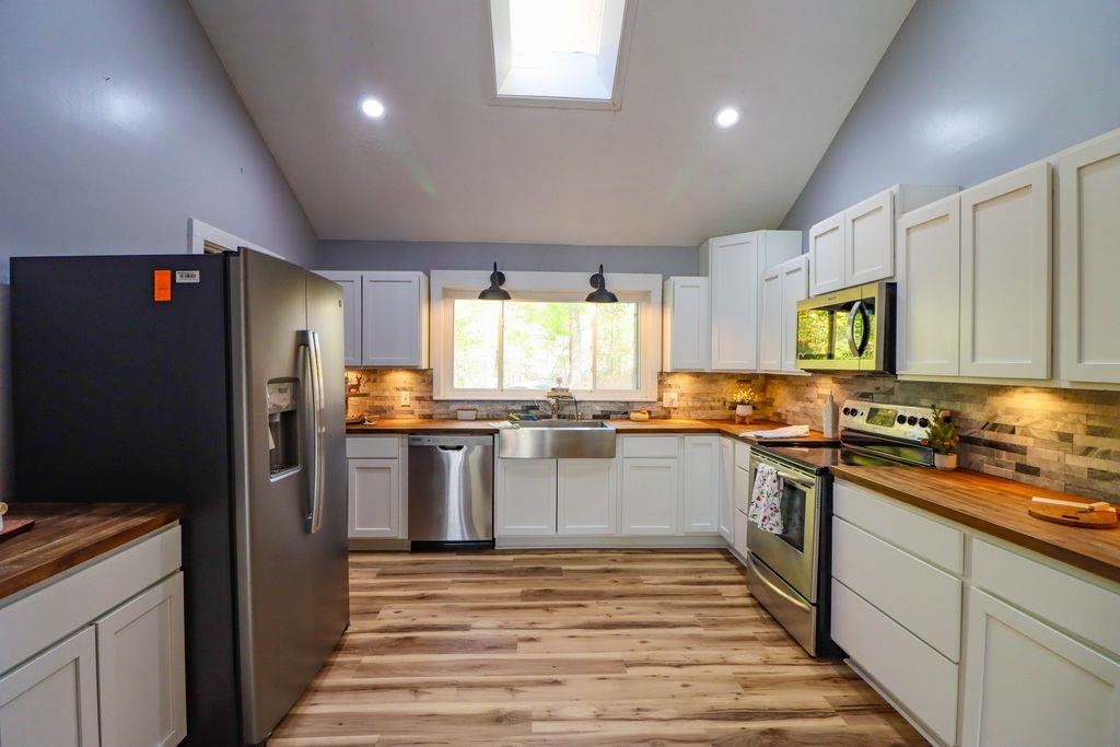 205 Charles Martin Road Ripley, TN 38063 - Photo 12 of 34 a kitchen with a sink stainless steel appliances cabinets and a counter top space