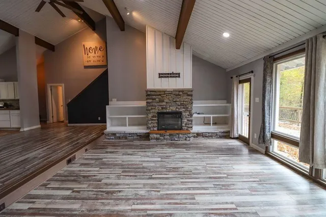 an empty room with windows and closet