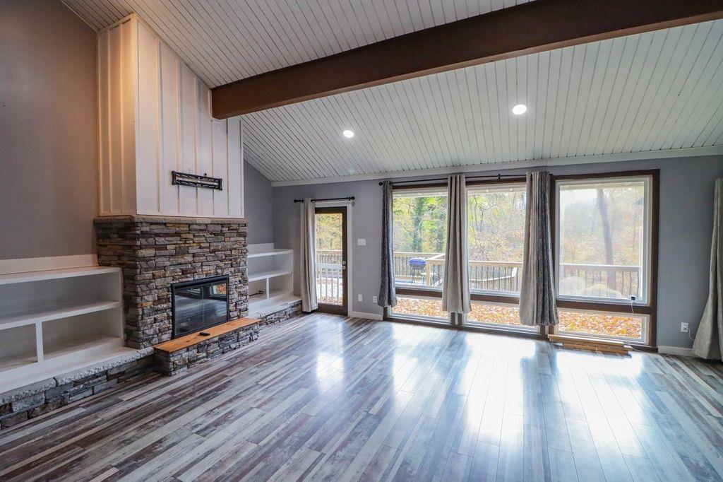 205 Charles Martin Road Ripley, TN 38063 - Photo 16 of 34 wooden floor in an empty room with a fireplace