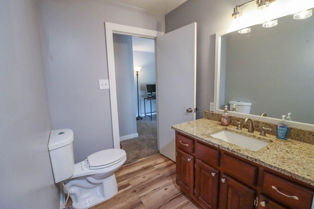 205 Charles Martin Road Ripley, TN 38063 - Photo 22 of 34 a bathroom with a granite countertop toilet sink and mirror