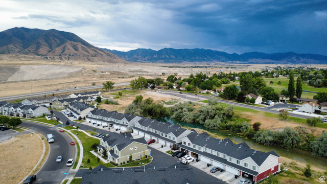 562 Hal Street, Unit 152 Tooele, UT 84074 - Photo 42 of 44 Aerial overview featuring a community of multi-story townhomes with dark shingled roofs and varied exterior siding