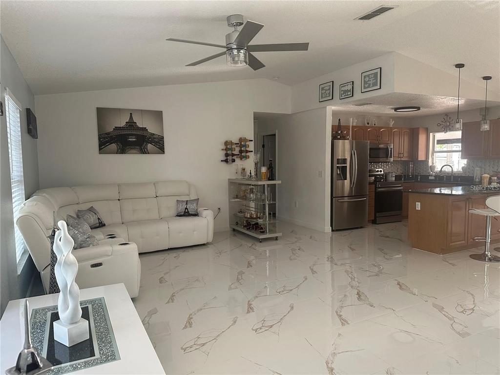 10520 Henderson Road Tampa, FL 33625 - Photo 5 of 9 a living room with furniture and a kitchen