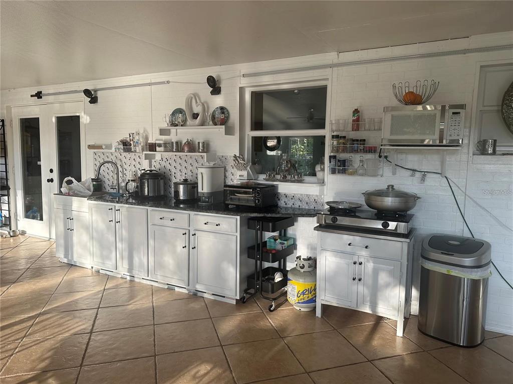 10520 Henderson Road Tampa, FL 33625 - Photo 9 of 9 a kitchen with stainless steel appliances a stove a sink and a microwave