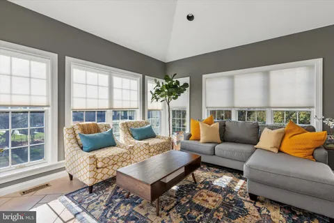 a living room with furniture a large window and a fireplace