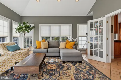 a living room with furniture a fireplace and a large window