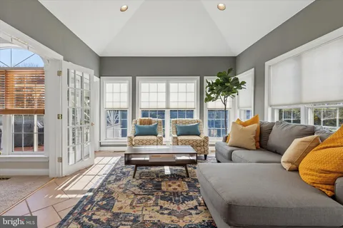 a living room with a fireplace and a large window