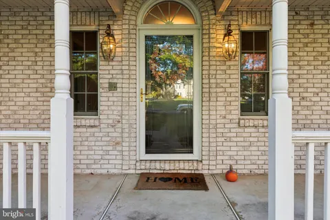 a view of an entryway with wooden floor door and a front door