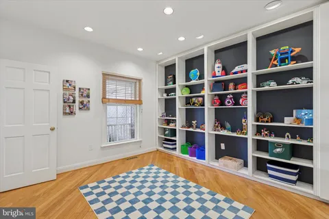 a spacious bedroom with a bed and dresser