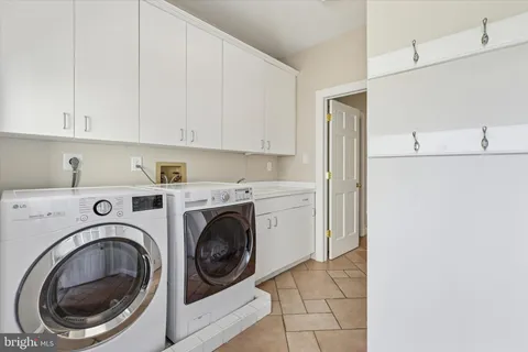 a bathroom with a bathtub and double sink