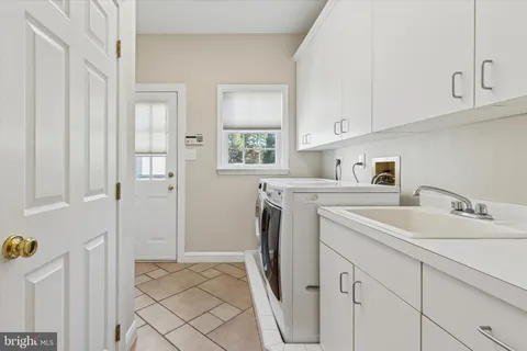 a spacious bathroom with a granite countertop tub sink and mirror