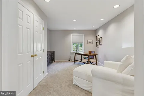 a bedroom with a bed dresser and a window