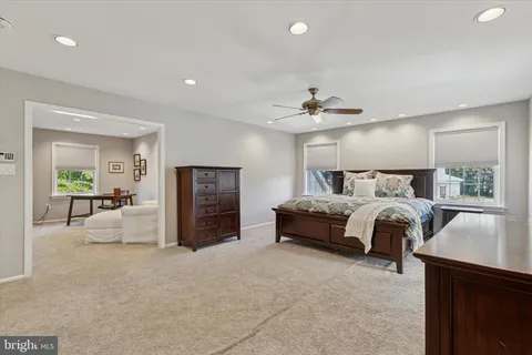 a spacious bedroom with a bed and a couch