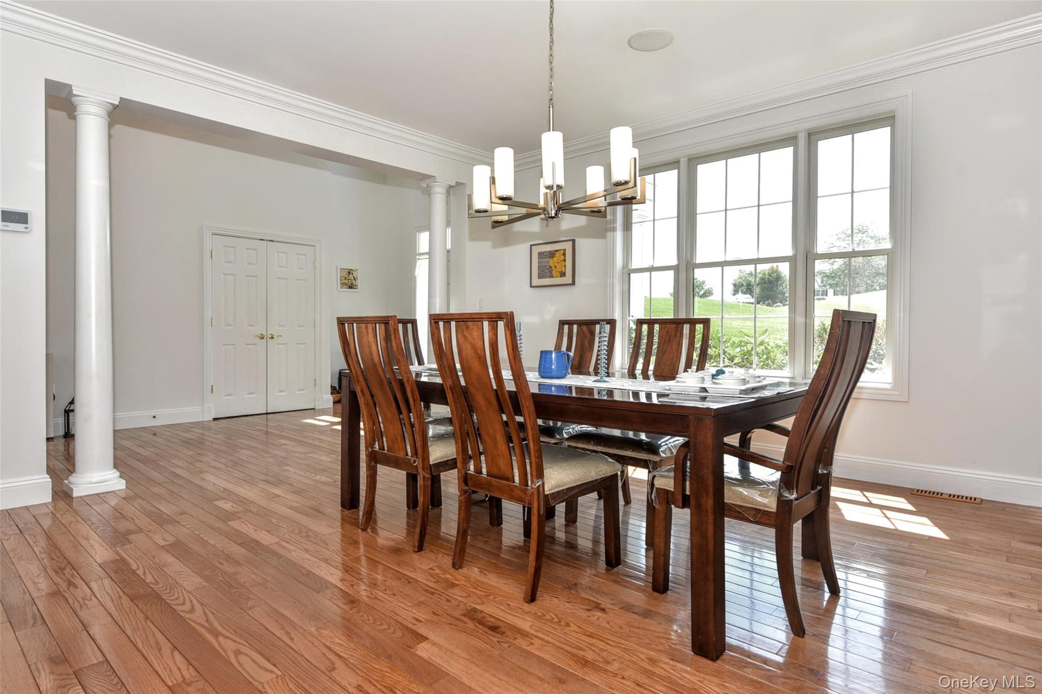 46 Mansion Ridge Boulevard Monroe, NY 10950 - Photo 12 of 46 Dining area featuring wood-finish flooring, a contemporary chandelier, and large windows