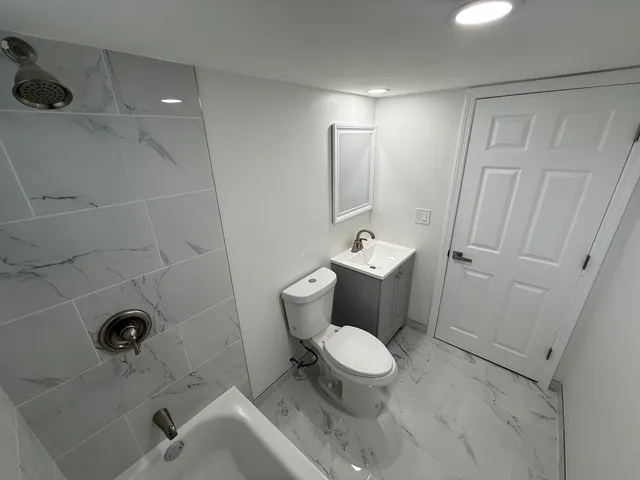 a bathroom with a toilet sink and shower