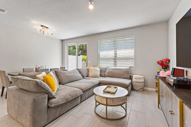 a kitchen with stainless steel appliances a sink dishwasher stove refrigerator and cabinets