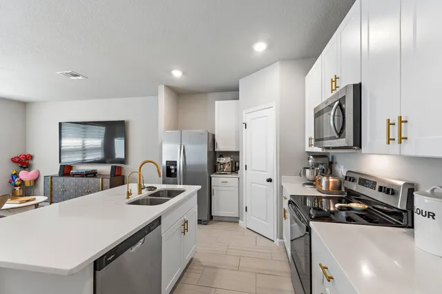 a view of kitchen with sink microwave and stove