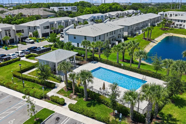 an aerial view of multiple houses with yard