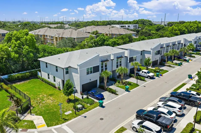 an aerial view of residential houses with outdoor space