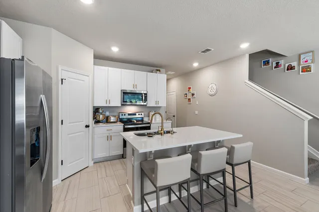 a kitchen with a sink stove and microwave