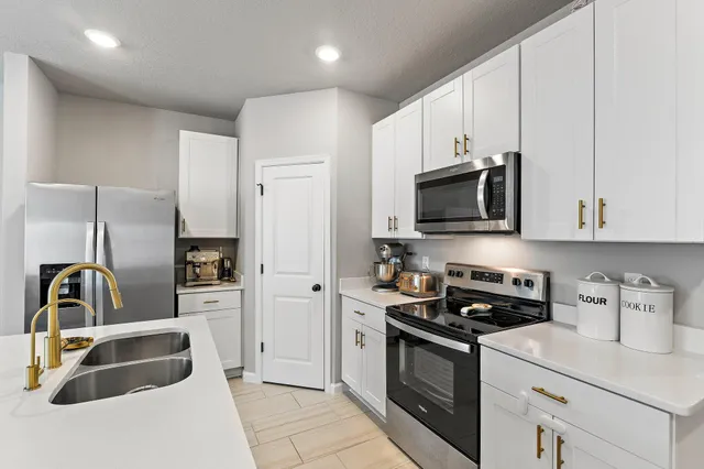 a living room with furniture and kitchen view