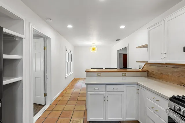 a kitchen with a sink and cabinets