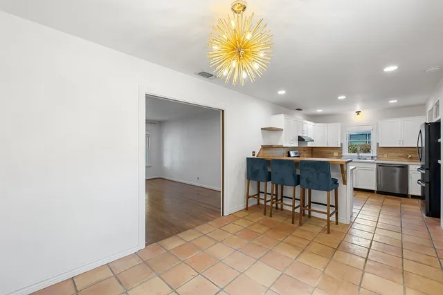 a kitchen with a sink cabinets and appliances