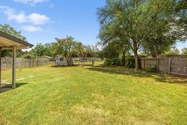 a swimming pool with outdoor seating and yard