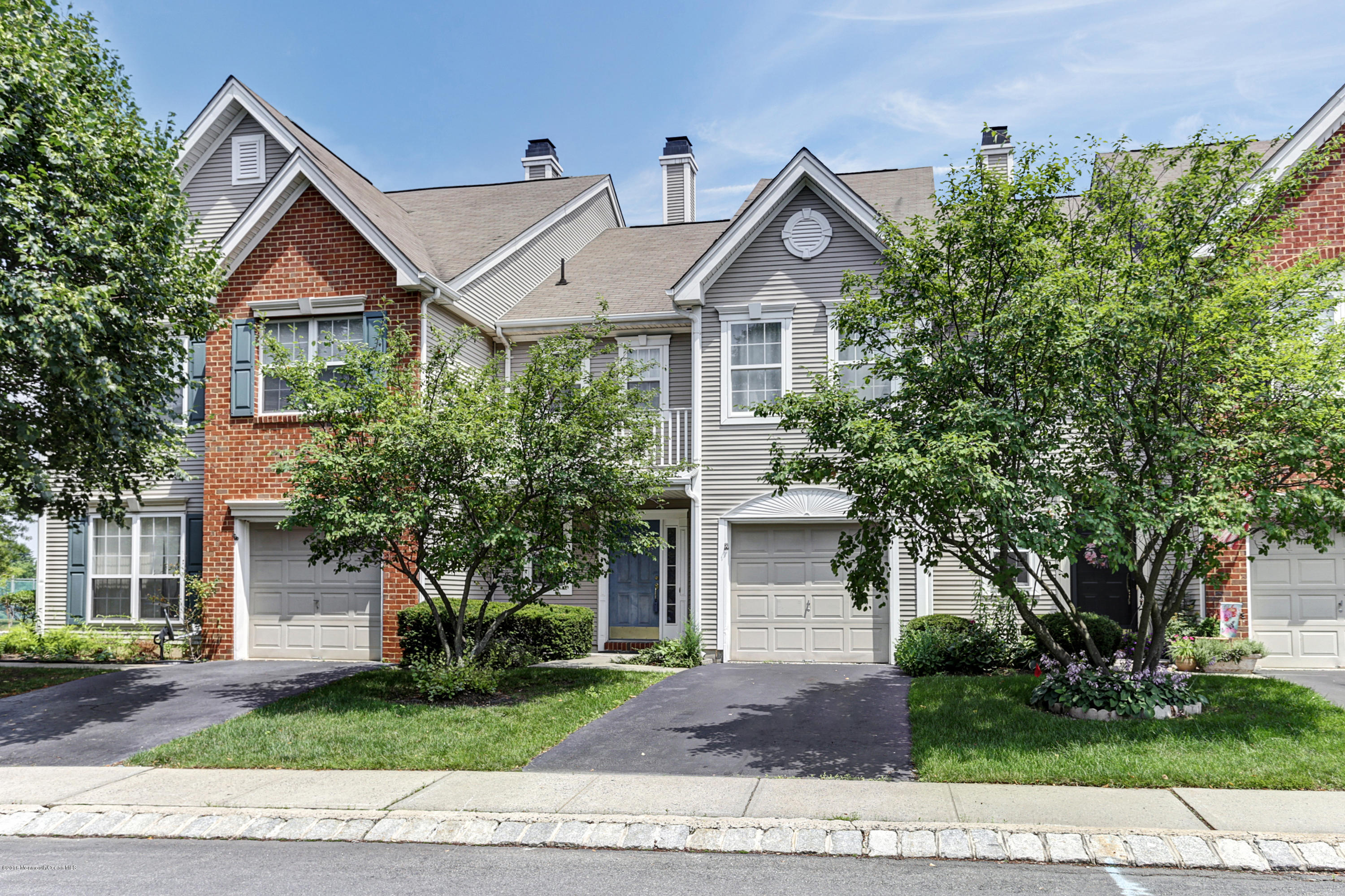 44 Bristel Road Holmdel, NJ 07733 - Photo 1 of 22 a front view of a house with a yard and a garage