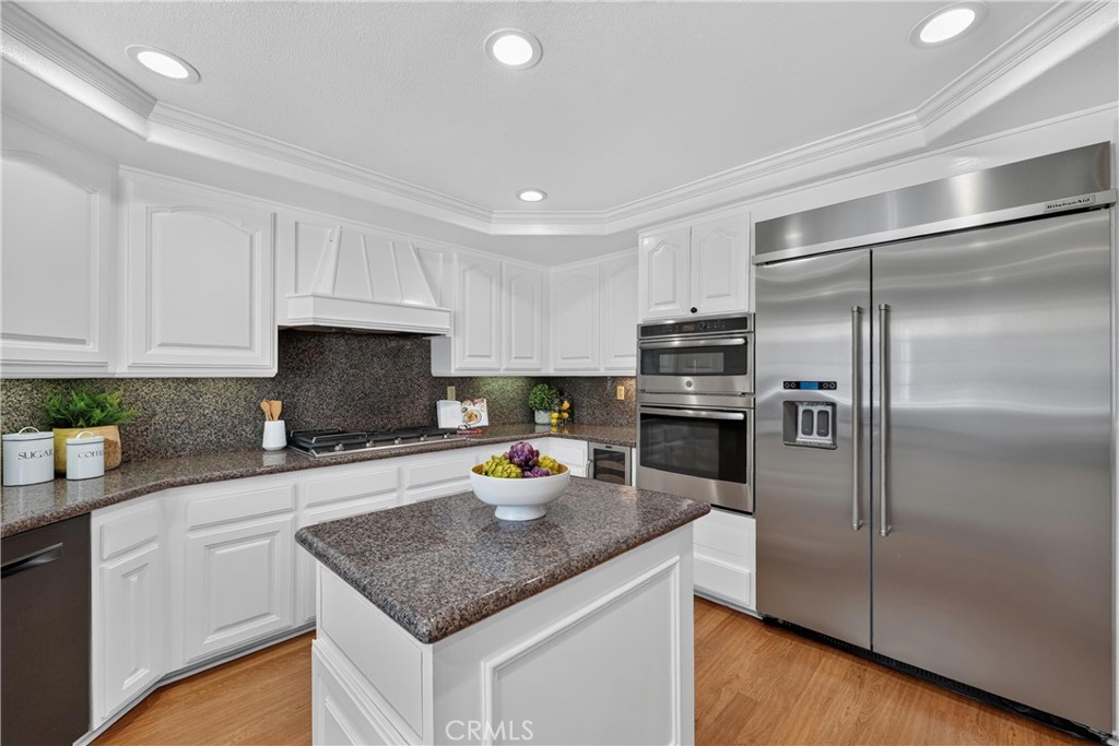 2935 Bluebell Avenue Brea, CA 92821 - Photo 9 of 38 Beautiful kitchen with granite countertops, breakfast bar, stainless steel appliances, and an oversized refrigerator