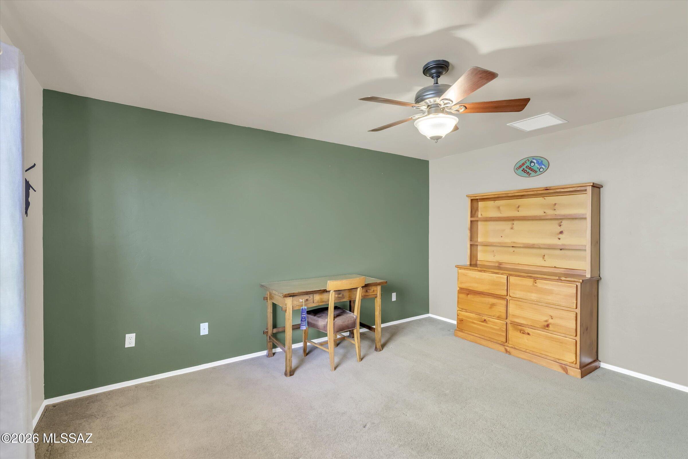 6095 South Jakemp Trail Tucson, AZ 85747 - Photo 33 of 52 a view of a room with toys and a ceiling fan